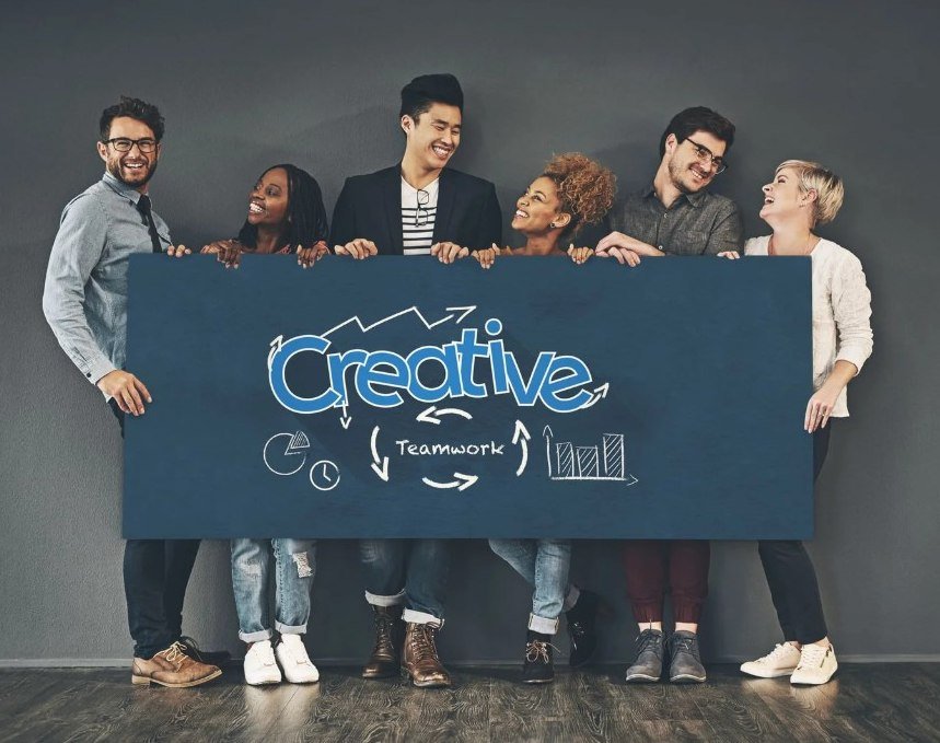 Diverse creative team collaborating at a multicultural marketing agency to develop innovative branding, marketing, and business growth strategies.